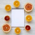 ÃÂ¡itrus fruits sicilian orange, grapefruit, orange with notepad on white wooden surface. Flat lay. From above, overhead